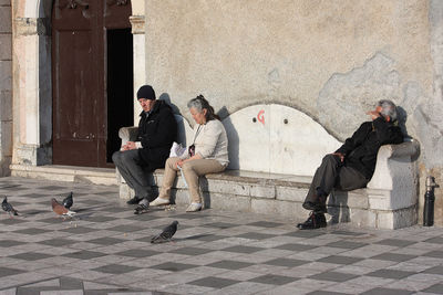Two men sitting on floor