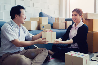 Young couple sitting in a box