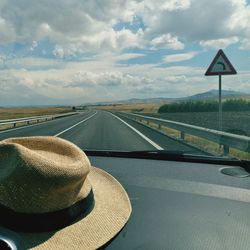 Road against sky seen through car windshield