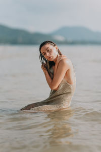 Portrait of young woman in sea