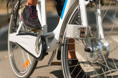 Low section of person with bicycle on street