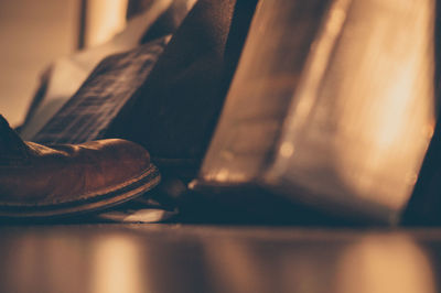 Close-up side view of cropped shoe on floor