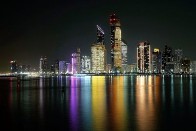 Illuminated city at waterfront