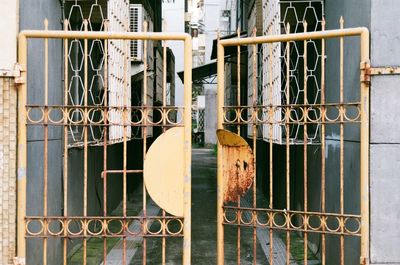 Close-up of metal fence against building