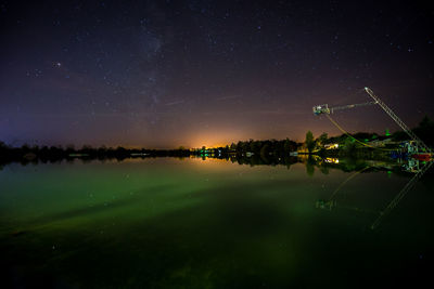 Scenic view of lake against sky at night