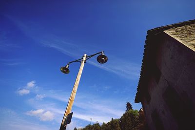 Low angle view of street light against blue sky