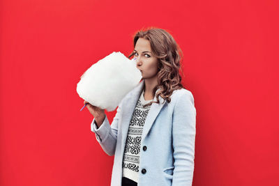 Portrait of woman eating cotton candy