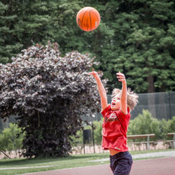 Full length of boy playing with ball