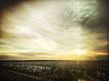 Scenic view of field against sky at sunset