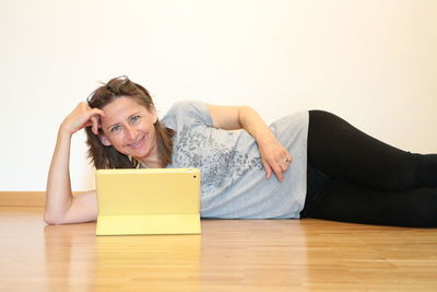 Portrait of woman sitting on table at home