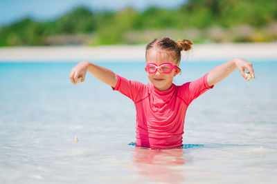 Portrait of young woman swimming in sea