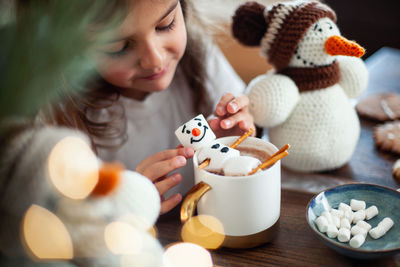 Close-up of girl holding food on table