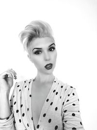 Portrait of young woman against white background
