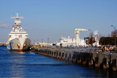 Boats in sea against clear sky