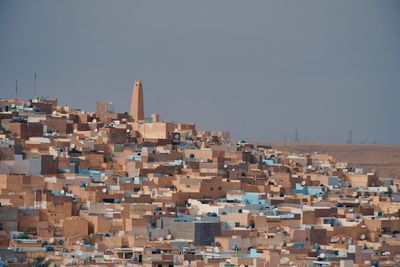 Buildings in city against clear sky