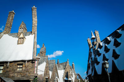 Low angle view of traditional building against blue sky