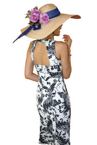 Rear view of woman wearing hat while standing against white background