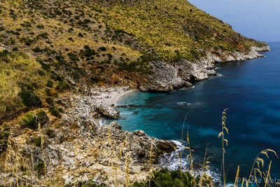 High angle view of rocks on sea shore