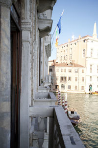 Boats in canal amidst buildings in city