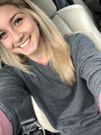 Portrait of smiling woman sitting in car