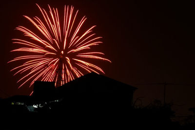 Low angle view of firework display at night