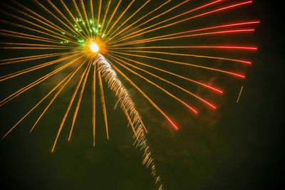 Low angle view of firework display at night