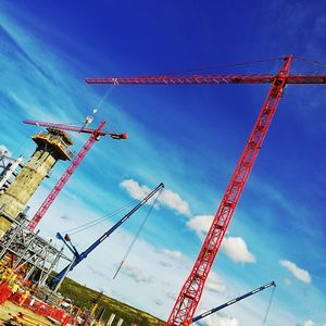 Low angle view of crane against blue sky