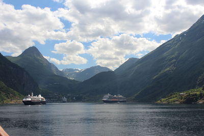 Scenic view of sea and mountains against sky