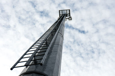 Low angle view of modern building against cloudy sky