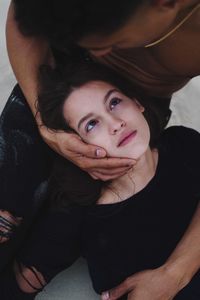 Portrait of young woman lying in her boyfriend arms