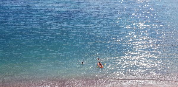 High angle view of people swimming in sea