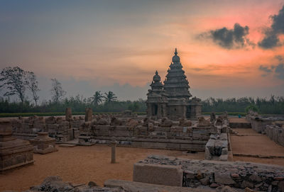 Shore temple against sky during sunset