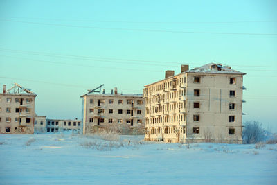 Buildings against blue sky during winter