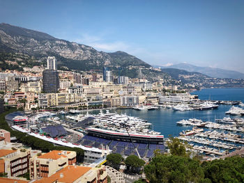 High angle view of townscape by sea against sky