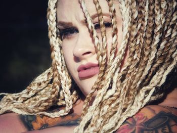 Close-up portrait of woman with braided hair