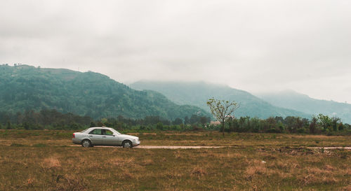 View of car on land against mountains