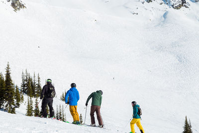 People walking on snow covered mountain