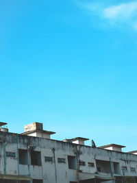 Low angle view of buildings against blue sky