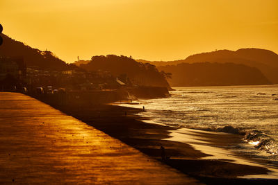 Scenic view of sea against orange sky　during sunrise