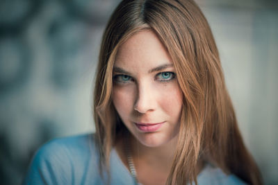 Close-up portrait of young woman at home