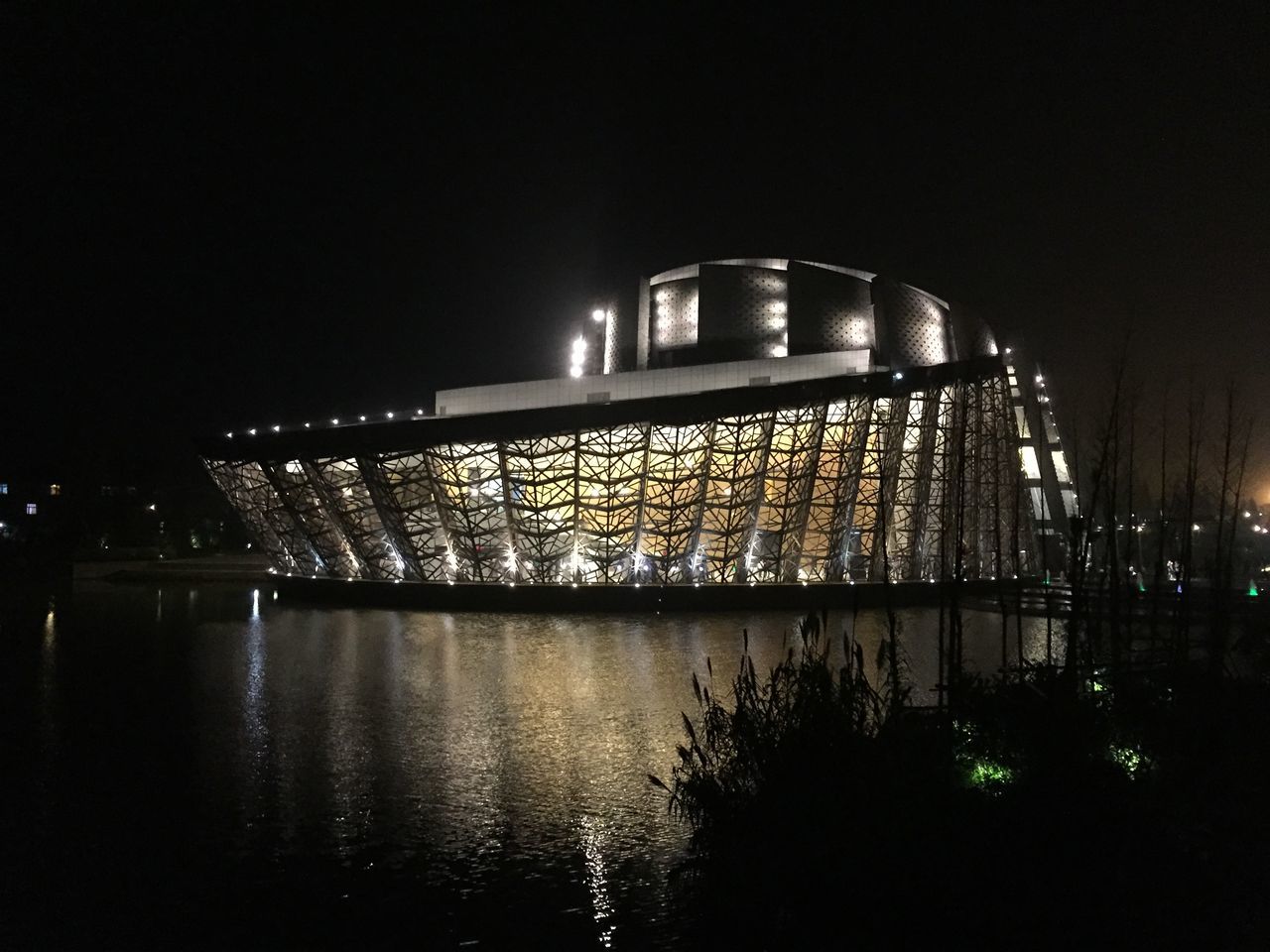 night, architecture, built structure, illuminated, building exterior, reflection, water, river, bridge - man made structure, connection, clear sky, waterfront, no people, sky, outdoors, city, dark, railing, building, copy space