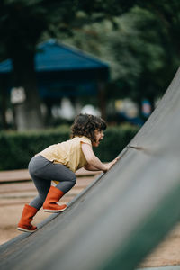 Side view of woman sitting outdoors