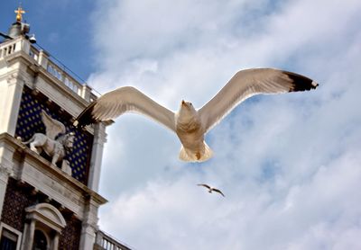 Low angle view of building against cloudy sky