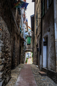 Cobblestone street amidst buildings in city
