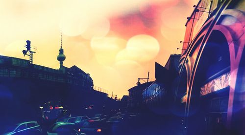 Low angle view of illuminated street light against sky at sunset
