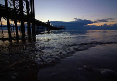 Pier over sea during sunset