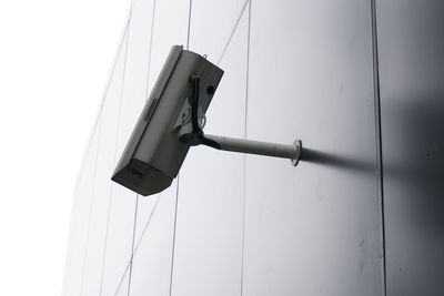 Low angle view of security camera on wall