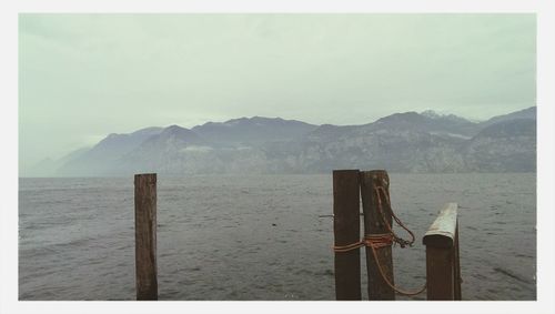 Scenic view of sea and mountains against sky