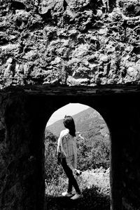 Rear view of man walking in tunnel