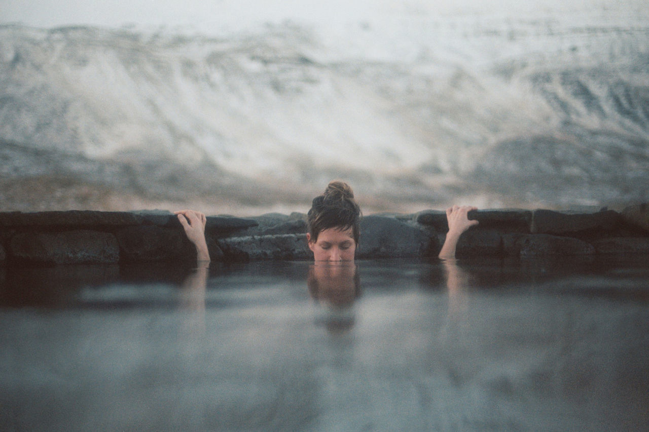 one person, portrait, looking at camera, water, lifestyles, real people, leisure activity, headshot, young adult, front view, nature, men, adult, outdoors, reflection, human body part, young men